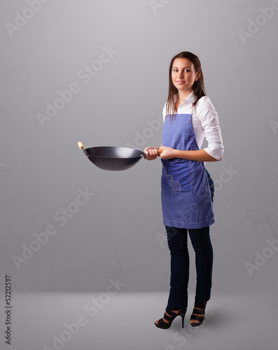 Photo: Young lady holding a frying pan Young lady holding a frying pan
