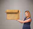 Young woman holding an empty cardboard box
