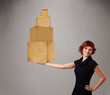 Young lady holding a set of brown cardboard boxes