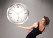 Photo: Attractive lady holding a huge clock Attractive lady holding a huge clock