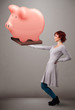 Young girl holding a huge savings piggy bank