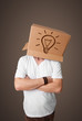 Young man gesturing with a cardboard box on his head with light
