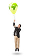 Photo: handsome man holding a green globe balloon handsome man holding a green globe balloon