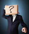 Businessman gesturing with a cardboard box on his head with ques