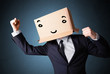Businessman gesturing with a cardboard box on his head with smil