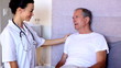 Home nurse talking with patient