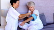 Home nurse checking patients blood pressure