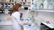 Female pharmacist putting in order medicine in lab