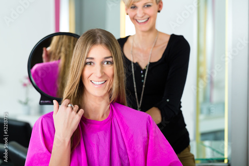 Photo: Woman at the hairdresser getting advise Woman at the hairdresser getting advise