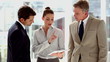 Business people using tablet together