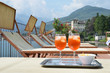 Photo: Traditional Italian Spritz cocktail against lake Como, Italy Traditional Italian Spritz cocktail against lake Como, Italy