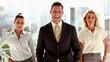 Three smiling business people posing