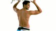 Attractive man holding a surfboard above his head