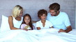 Family sitting in bed