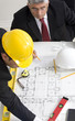 Foto: Above view of architects sitting at the table and discussing des Above view of architects sitting at the table and discussing des
