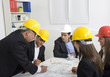 Foto: Architects working in office on construction project Architects working in office on construction project