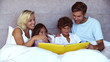 Parents reading a funny story to their children