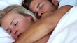 Couple cuddling in bed