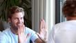 Son punching his fathers hands who is encouraging him