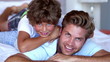 Father and son smiling at the camera together