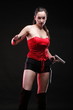 Sexy young woman - gun on black background