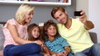 Father taking self portrait of him with smiling family