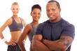 handsome male personal trainer and team