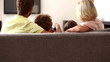 Rear view of family watching tv