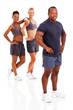 african man instructor posing with two gym members on background