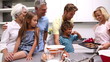 Mother serving freshly baked cookies to her extended family