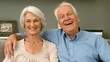 Elderly couple smiling and looking to the camera