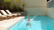 Attractive woman diving into swimming pool