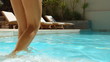 Woman coming down stairs of swimming pool