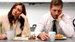 Distant couple having breakfast and not talking