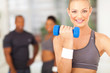fit woman working out with dumbbell