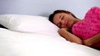 Woman holding pink heart cushion