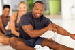african man with team stretching before exercise