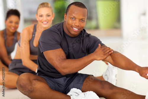 Photo: african man with team stretching before exercise african man with team stretching before exercise