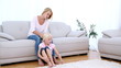 Mother playing with daughters blonde hair