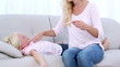 Mother checking her daughters temperature