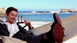 Buisnessman sitting in hammock throwing away his tie