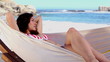 Pretty girl sunbathing in a hammock