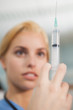 Focus on a syringe held by a nurse