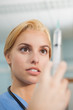 Focus on a nurse looking at a syringe