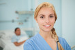 Close up of a blonde nurse looking at camera