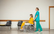 Nurse pushing the wheelchair of a patient