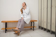 Doctor sitting on a bench while calling