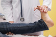 Doctor auscultating a patient ankle