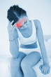 Woman rubbing her head with highlighted red pain