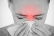 Woman blowing her nose with highlighted sinus pain